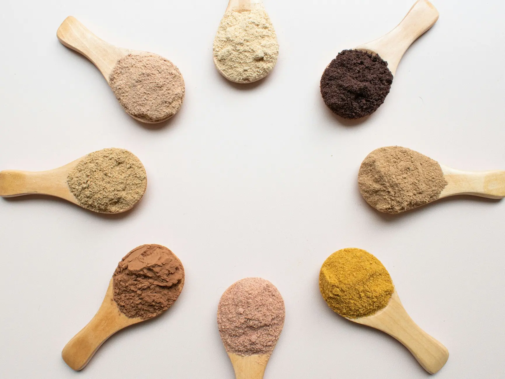 six different types of powdered spoons arranged in a circle